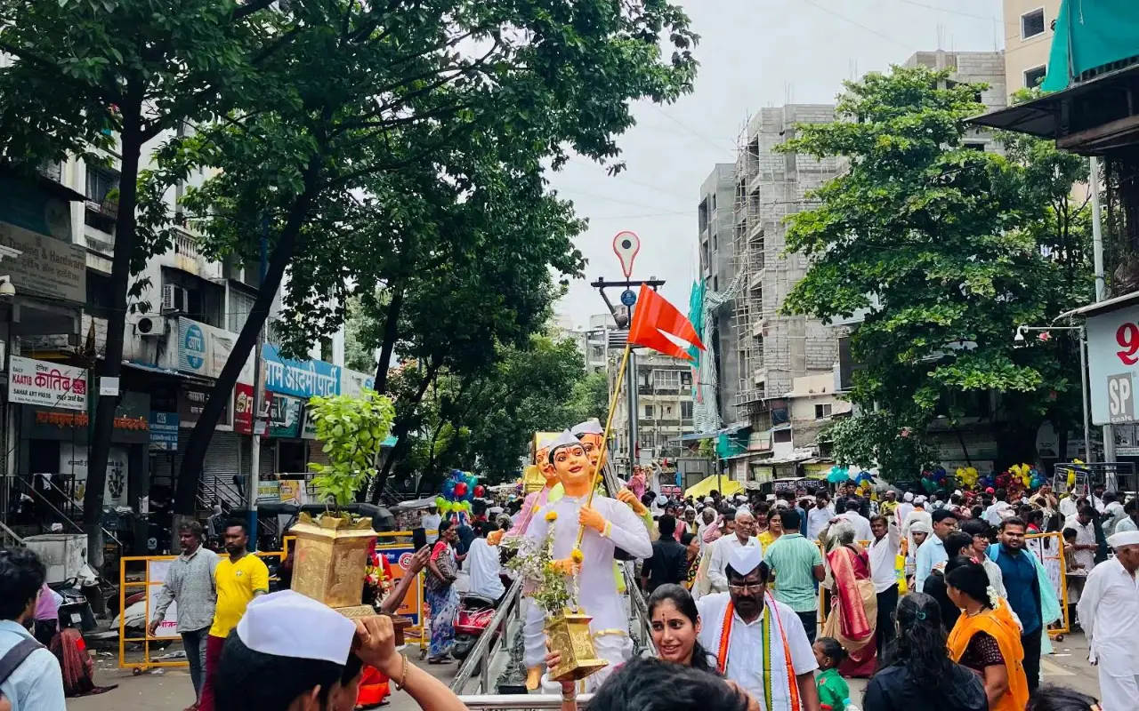 The Ashadhi Wari procession passing through a crowded street